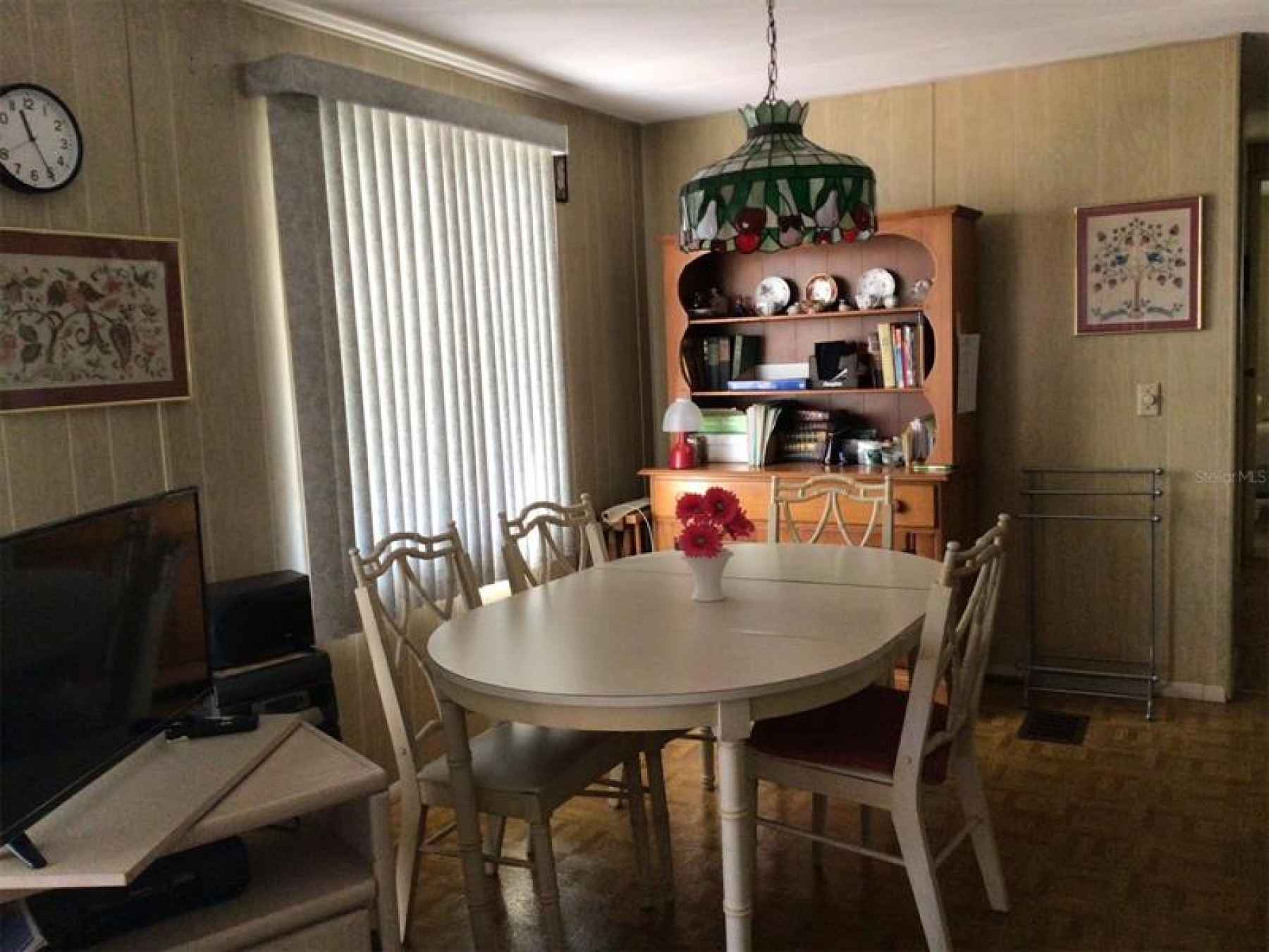 Dining room area with TV on the left. Seller loves she can be in the kitchen, dining room or living 