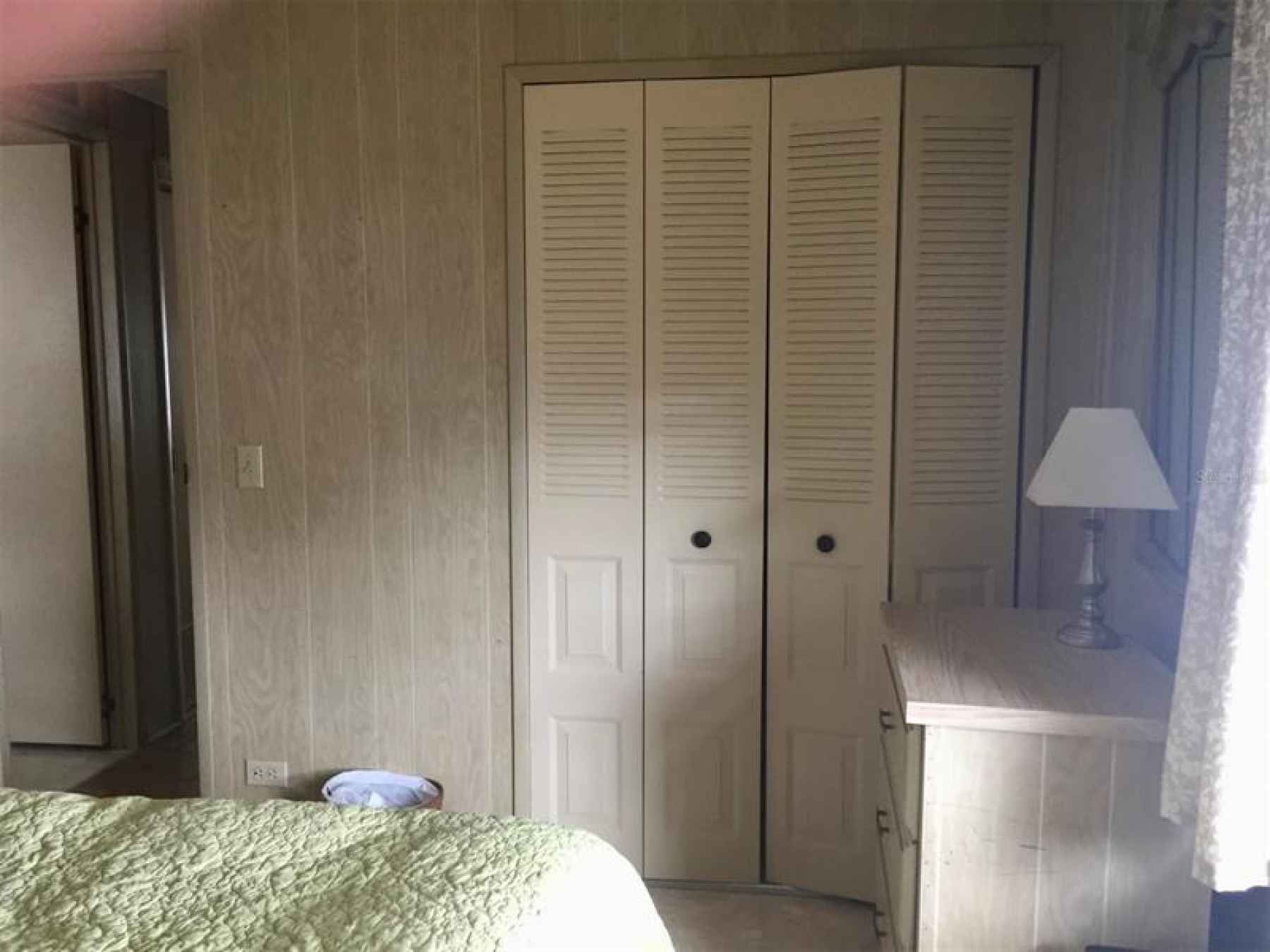 Other view of guest bedroom showing double closet doors.