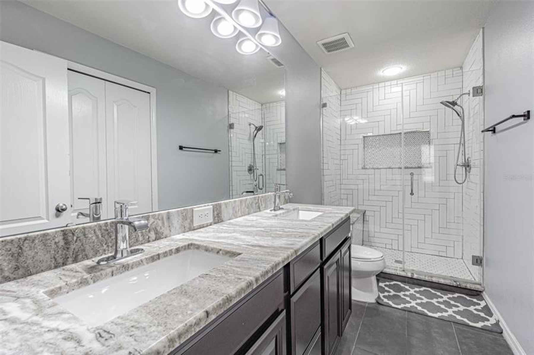Master bathroom features modern double vanities