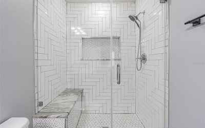 Built in shower bench and updated tiles give the shower a fresh clean look.