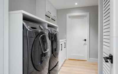 Huge laundry room with folding center, and plenty of storage for utility items and extra kitchen war