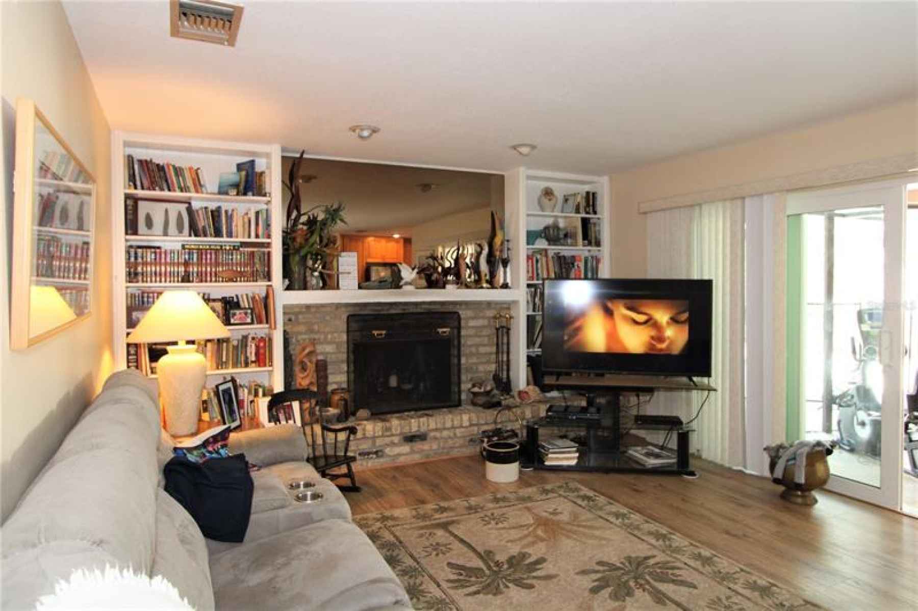 Family room offers access to enclosed pool and patio area.