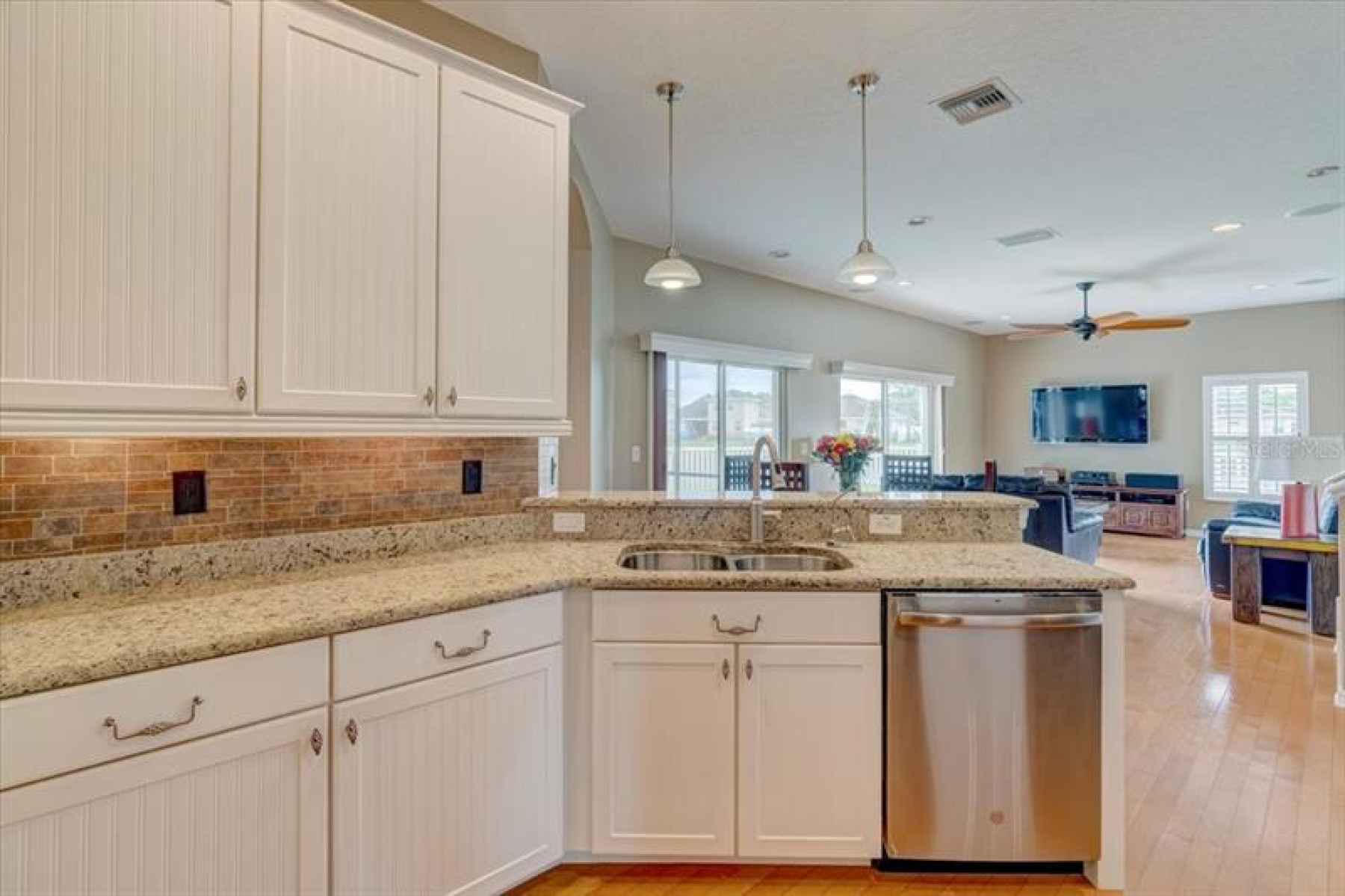Enjoy the beautiful, open kitchen, with granite counters and wood cabinetry, overlooking the family 