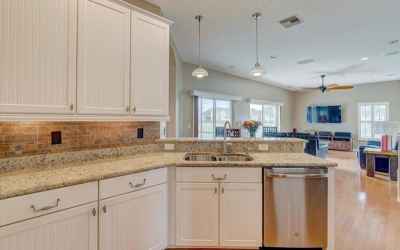 Enjoy the beautiful, open kitchen, with granite counters and wood cabinetry, overlooking the family 