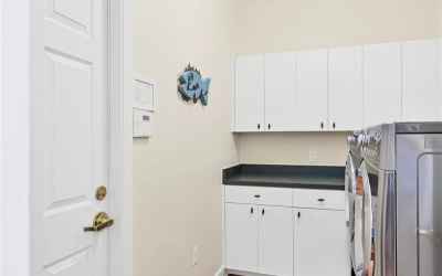 Laundry room with countertop for folding clothes and washer and dryer convey