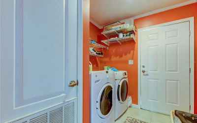 VERY SPACIOUS LAUNDRY ROOM WITH ACCESS TO THE SIDE OF THE HOME!