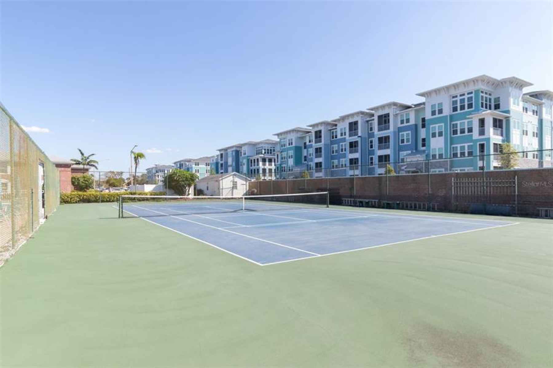 Tennis courts.  New luxury apts in background.