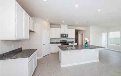 A great room concept with an open Kitchen overlooking the pond and features sparkling granite counte
