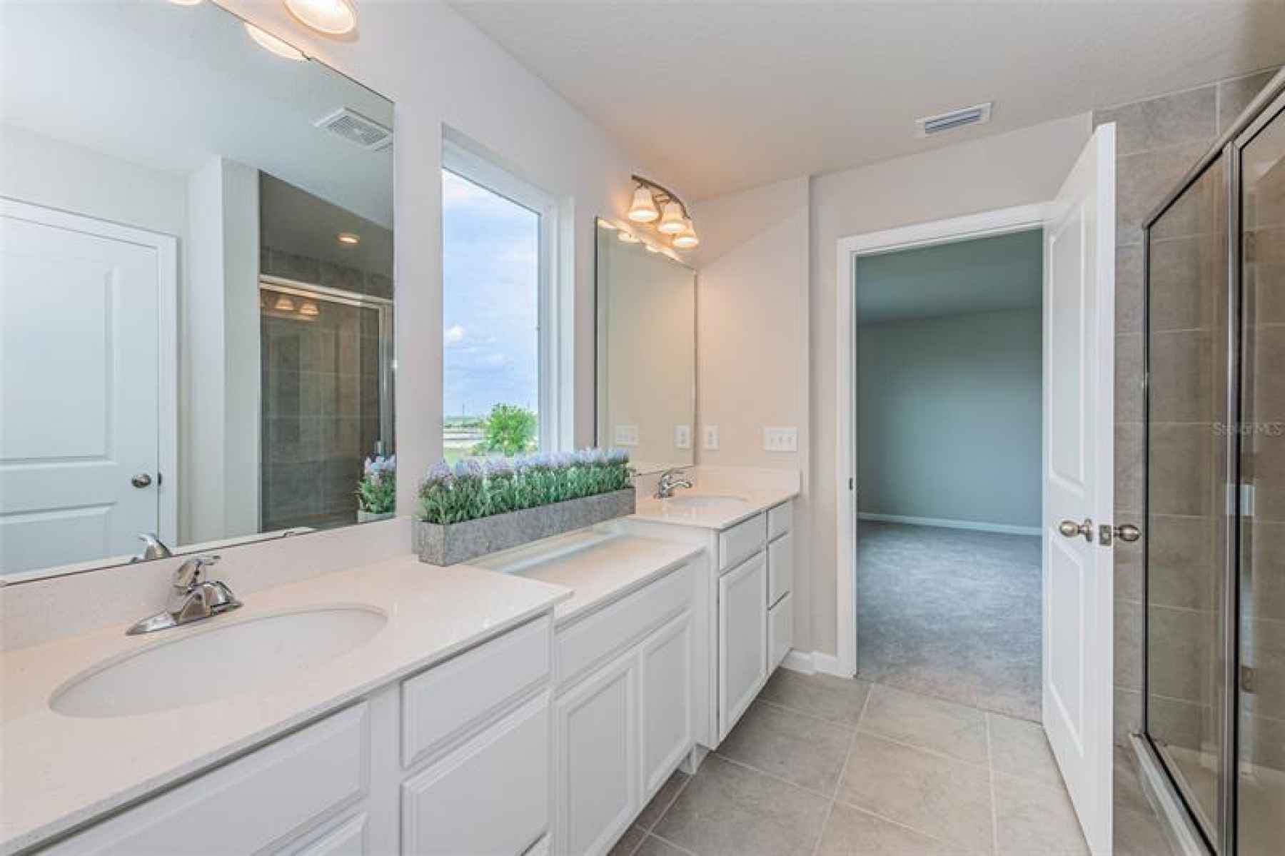 Owner's Suite Bath with dual sinks, make-up area, separate shower, water closet and one of two walk-