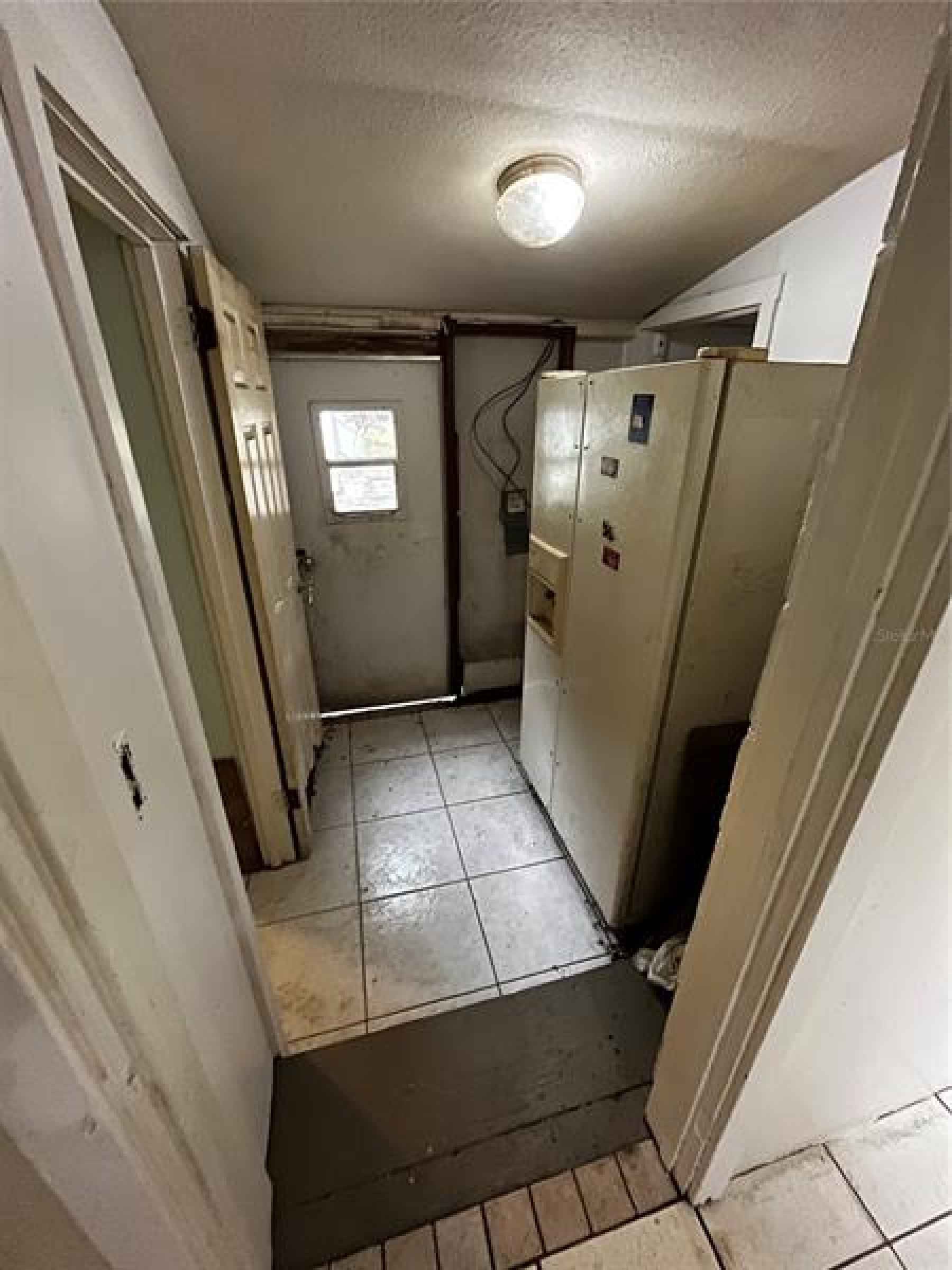 Hallway to back door. Bathroom on the left and utility room on the right.