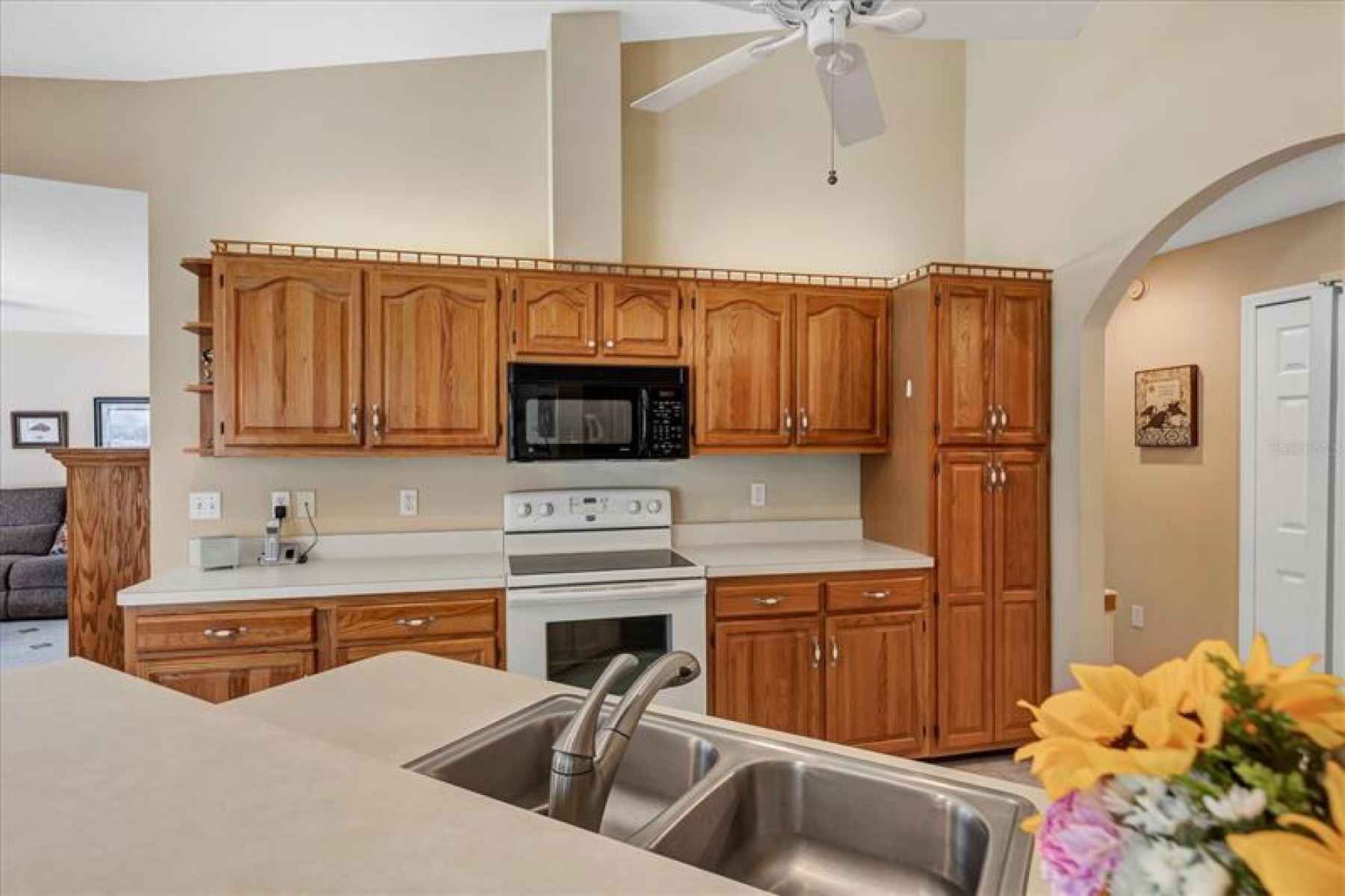 Solid surface counter tops and wood cabinets grace the kitchen