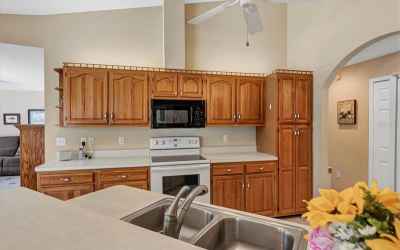 Solid surface counter tops and wood cabinets grace the kitchen