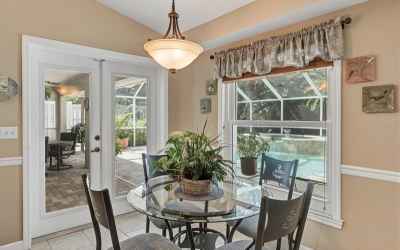 French doors open the breakfast nook to the pool deck