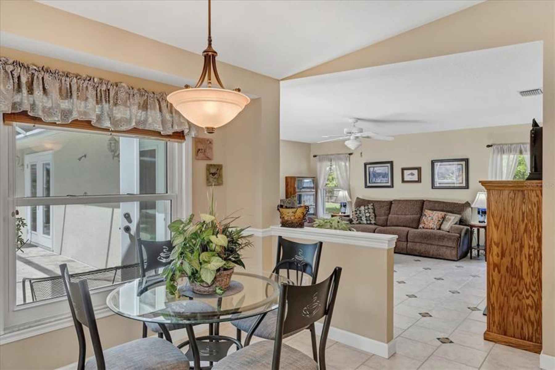 An open concept floor plan leads breakfast nook into the family room
