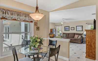An open concept floor plan leads breakfast nook into the family room