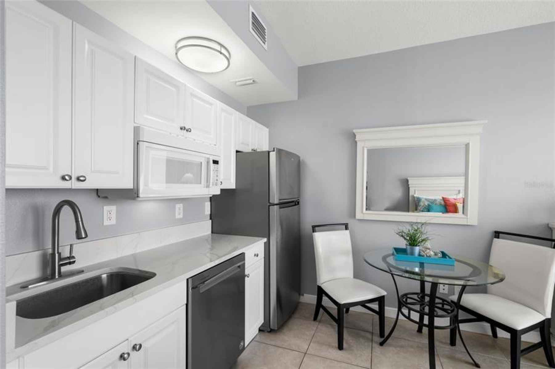Hip-height counters, plenty of storage, stainless steel appliances & new quartz countertops.